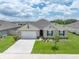 Charming single Gathering home with a manicured lawn and a two car garage at 715 Auburn Grove Ct, Auburndale, FL 33823