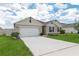Charming single Gathering home with a manicured lawn, landscaping, and a two car garage at 715 Auburn Grove Ct, Auburndale, FL 33823