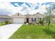 Charming single Gathering home with a manicured lawn, landscaping, and a two car garage at 715 Auburn Grove Ct, Auburndale, FL 33823