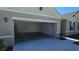 Spacious attached two car garage with a roll up door at 715 Auburn Grove Ct, Auburndale, FL 33823