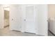 Hallway with doors to a bathroom with granite counters and a laundry closet with a washer at 715 Auburn Grove Ct, Auburndale, FL 33823