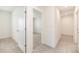 Hallway with an open doorway to a carpeted bedroom and modern tiled floors throughout at 715 Auburn Grove Ct, Auburndale, FL 33823