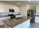Island kitchen with granite countertops, stainless appliances and white cabinets at 715 Auburn Grove Ct, Auburndale, FL 33823