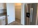 Bright kitchen area with stainless steel refrigerator, granite countertops and pantry at 715 Auburn Grove Ct, Auburndale, FL 33823