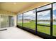 Screened lanai providing views of a pond, lawn and neighborhood at 715 Auburn Grove Ct, Auburndale, FL 33823