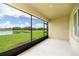 Screened lanai with view of the beautiful pond, lawn, and neighborhood at 715 Auburn Grove Ct, Auburndale, FL 33823