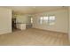 Open concept living area with carpet flooring and large windows at 715 Auburn Grove Ct, Auburndale, FL 33823