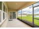 Enjoy the screened patio with serene views of the pond and lush green lawn at 715 Auburn Grove Ct, Auburndale, FL 33823