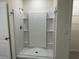 Modern shower featuring built in shelves and white panelling at 715 Auburn Grove Ct, Auburndale, FL 33823
