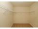 Walk-in closet features carpeted floor and built-in metal shelving at 715 Auburn Grove Ct, Auburndale, FL 33823