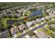 Picturesque aerial view of a home near a lake, surrounded by mature trees in a lush, green neighborhood at 7263 Winding Lake Cir, Oviedo, FL 32765