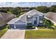 Beautiful home with a large backyard, situated near a tranquil lake and lush greenery at 7263 Winding Lake Cir, Oviedo, FL 32765