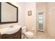 Bathroom features a single vanity, toilet, and shower with access to the backyard at 7263 Winding Lake Cir, Oviedo, FL 32765