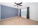 Bedroom featuring neutral carpet, ceiling fan, and natural light from the window at 7263 Winding Lake Cir, Oviedo, FL 32765