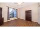 Cozy bedroom showcasing a large window, a bookcase, and tile floors, bathed in natural light at 7263 Winding Lake Cir, Oviedo, FL 32765