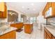 Bright eat-in kitchen featuring granite countertops, a kitchen island, and white appliances at 7263 Winding Lake Cir, Oviedo, FL 32765
