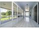 Enclosed lanai features tile flooring and views of the pond at 7263 Winding Lake Cir, Oviedo, FL 32765