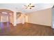 Spacious living room with wood-look floors and seamless flow to the foyer at 7263 Winding Lake Cir, Oviedo, FL 32765