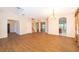 Open-concept living room with tile floors, arched doorways, and a chandelier, creating an inviting space at 7263 Winding Lake Cir, Oviedo, FL 32765