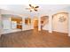 Bright open-concept living area with tile floors connecting the kitchen and staircase at 7263 Winding Lake Cir, Oviedo, FL 32765