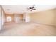 Large, carpeted loft area featuring ceiling fan and views of the stairway at 7263 Winding Lake Cir, Oviedo, FL 32765
