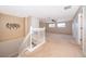 Open loft space with neutral carpet, white railing, and plenty of natural light at 7263 Winding Lake Cir, Oviedo, FL 32765