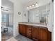 Bathroom boasts a double vanity with granite countertops and a view into the adjacent bedroom area at 7521 Marker Ave, Kissimmee, FL 34747