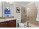 Well-lit bathroom with a glass shower, granite countertop, and view into a blue bedroom at 7521 Marker Ave, Kissimmee, FL 34747