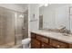 Bathroom featuring a glass-enclosed shower, granite countertop vanity, and modern fixtures at 7521 Marker Ave, Kissimmee, FL 34747