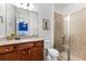 Bright bathroom featuring granite countertops, a modern shower, and a crisp white toilet at 7521 Marker Ave, Kissimmee, FL 34747