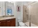 Well-lit bathroom with granite counters, a tiled shower, and modern fixtures at 7521 Marker Ave, Kissimmee, FL 34747