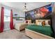 Themed bedroom featuring two twin beds, carpet, and a large Harry Potter mural at 7521 Marker Ave, Kissimmee, FL 34747
