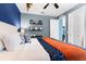 Bright bedroom showcasing modern decor, unique accents, and a comfortable bed with colorful pillows at 7521 Marker Ave, Kissimmee, FL 34747