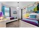 Fun ' bedroom featuring a colorful mural, carpeted floor, and two twin beds at 7521 Marker Ave, Kissimmee, FL 34747