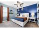 Stylish bedroom featuring unique wall decor, ample lighting and a comfortable bed with a decorative spread at 7521 Marker Ave, Kissimmee, FL 34747