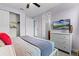 Cozy bedroom with a large dresser, TV, ceiling fan, and view into other rooms at 7521 Marker Ave, Kissimmee, FL 34747