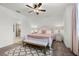 Bright bedroom featuring a ceiling fan, neutral walls and a cozy bed with bench seating at the foot at 7521 Marker Ave, Kissimmee, FL 34747