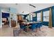 Open dining area with modern lighting and views into kitchen and comfortable bedroom at 7521 Marker Ave, Kissimmee, FL 34747
