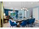 Open-concept dining and living area with stylish lighting and sliding door access to pool at 7521 Marker Ave, Kissimmee, FL 34747