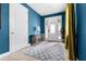 Bright blue foyer with a white door, ceramic tile, and eye-catching gold curtains at 7521 Marker Ave, Kissimmee, FL 34747