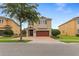 Charming two-story home with a brick driveway and a well-manicured lawn at 7521 Marker Ave, Kissimmee, FL 34747