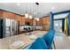 Modern kitchen with granite countertops, stainless steel appliances, and stylish pendant lighting at 7521 Marker Ave, Kissimmee, FL 34747