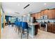 Open concept kitchen with stainless appliances, granite counters, breakfast bar, and pendant lights at 7521 Marker Ave, Kissimmee, FL 34747