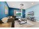 Cozy living room boasts a sectional sofa, stylish lighting, and sliding glass doors to the outdoor pool area at 7521 Marker Ave, Kissimmee, FL 34747