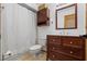 Traditional bathroom featuring a dark wood vanity, a tiled floor, and a shower with white curtain at 8554 Amber Oak Dr, Orlando, FL 32817