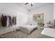 Cozy bedroom with neutral carpet, natural light, and a clothes rack; perfect for relaxation at 8554 Amber Oak Dr, Orlando, FL 32817
