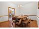 Formal dining room featuring hardwood floors, elegant lighting, and open access to the kitchen at 8554 Amber Oak Dr, Orlando, FL 32817