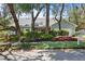 Charming single-story home featuring light-blue siding, mature trees, and lush landscaping at 8554 Amber Oak Dr, Orlando, FL 32817