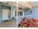Inviting front porch with hanging flower baskets and outdoor seating, creating a welcoming entrance at 8554 Amber Oak Dr, Orlando, FL 32817