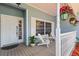 Inviting front porch with hanging flower baskets and seating, perfect for enjoying the outdoors at 8554 Amber Oak Dr, Orlando, FL 32817